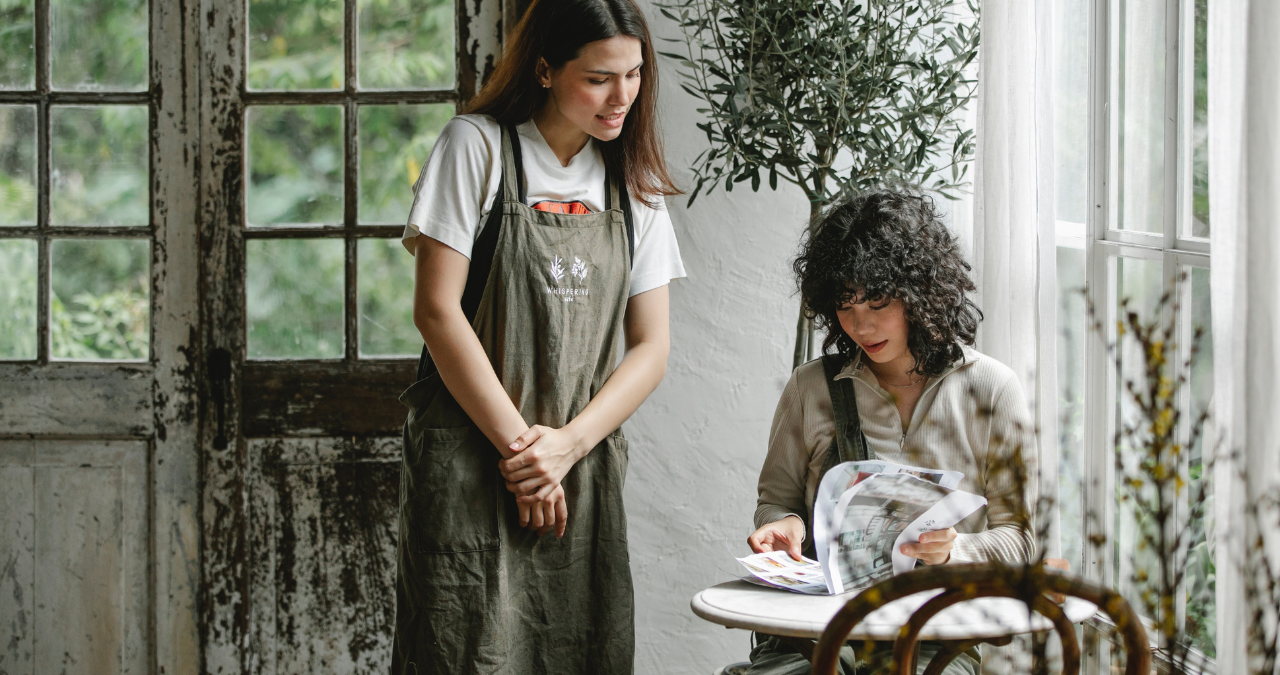 Two ladies looking at a booklet.